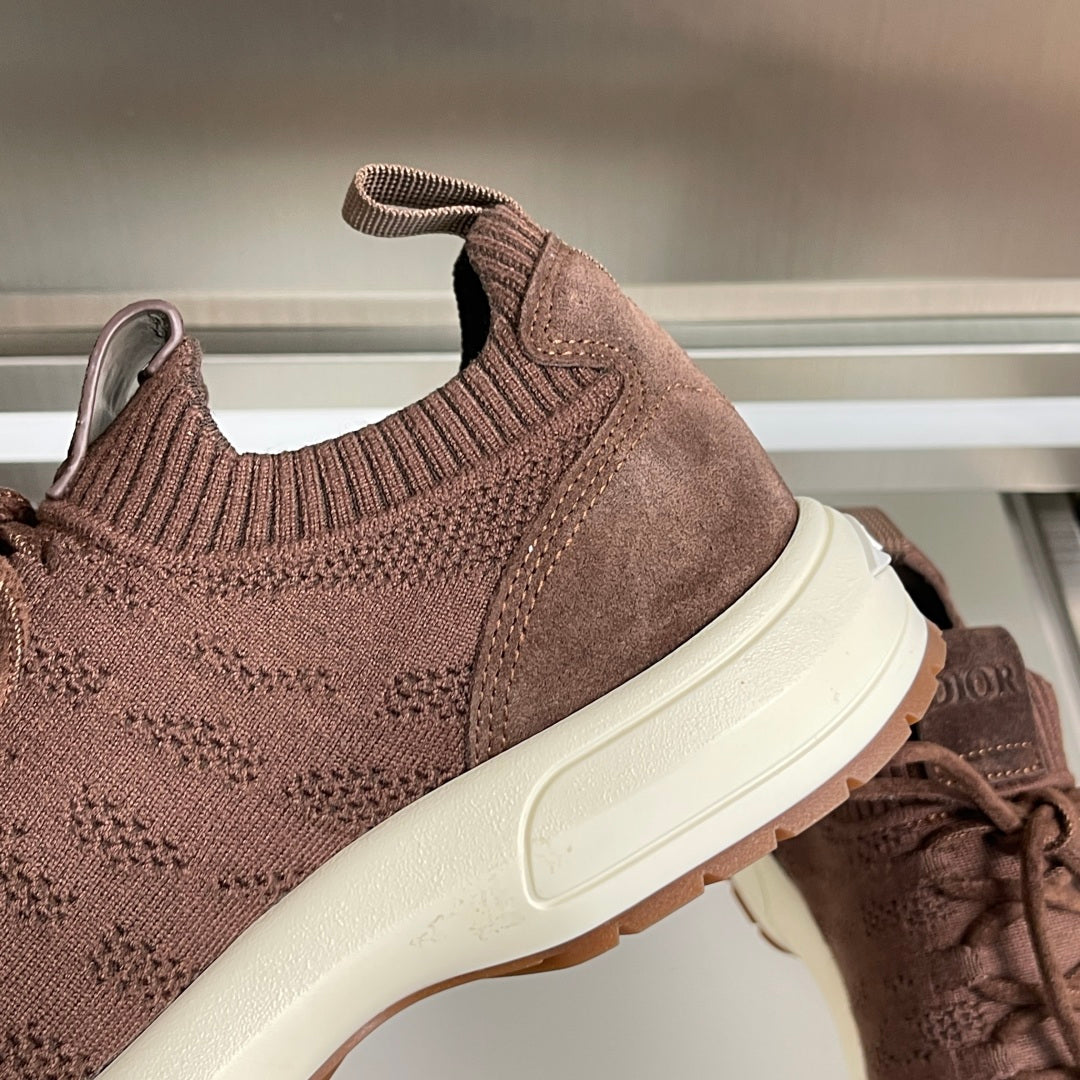 Dior unisex sneaker detail: dark brown knit panel, padded collar, and white sole