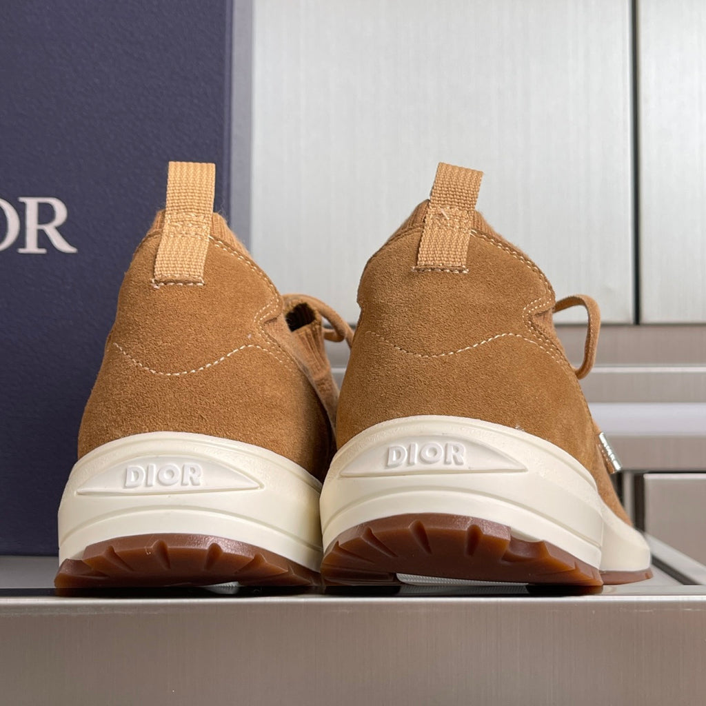 Rear view of tan unisex sneakers with ankle pull tabs and white rubber outsoles