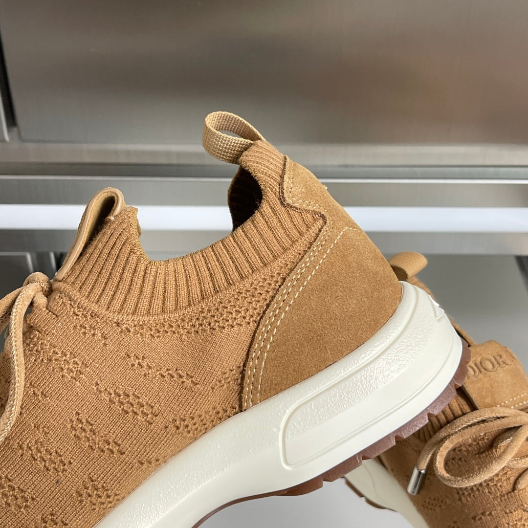 Tan unisex sneaker close-up with knit collar, suede side panel, and white sole