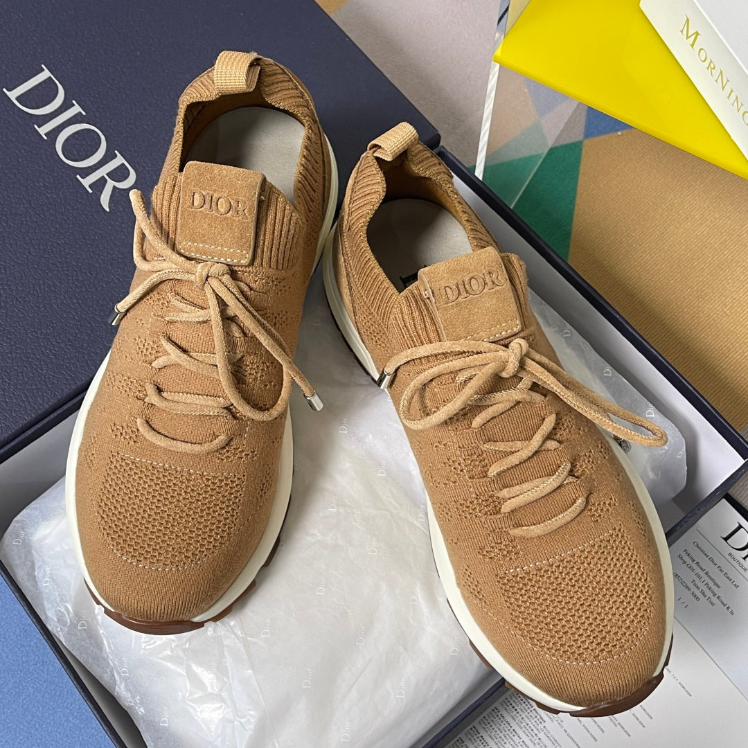 Tan unisex sneakers with lace-up knit upper, padded heel tab, and white rubber sole