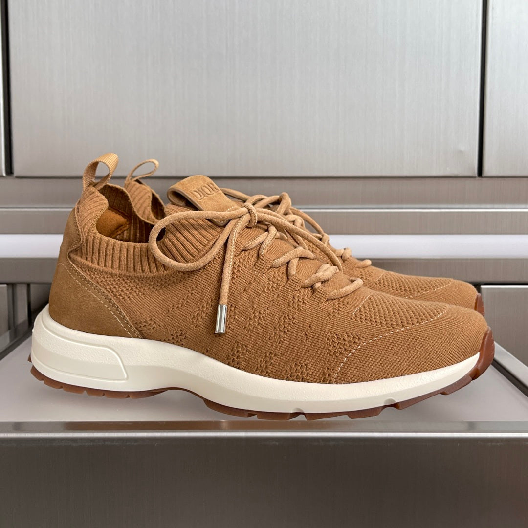 Tan unisex sneakers with knit upper, lace-up front, and white rubber sole