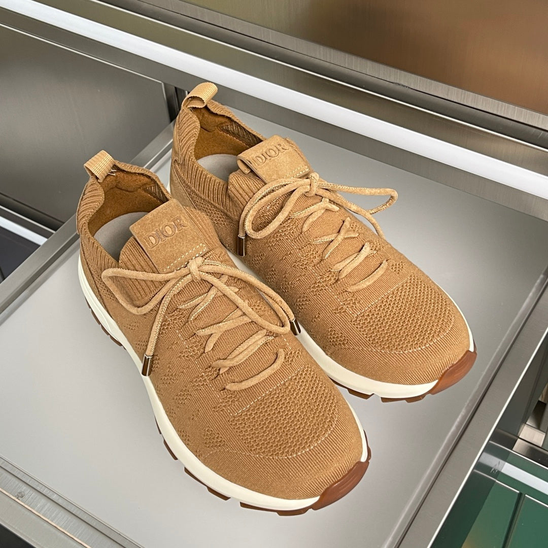 Pair of tan unisex sneakers with lace-up knit design and thick white sole