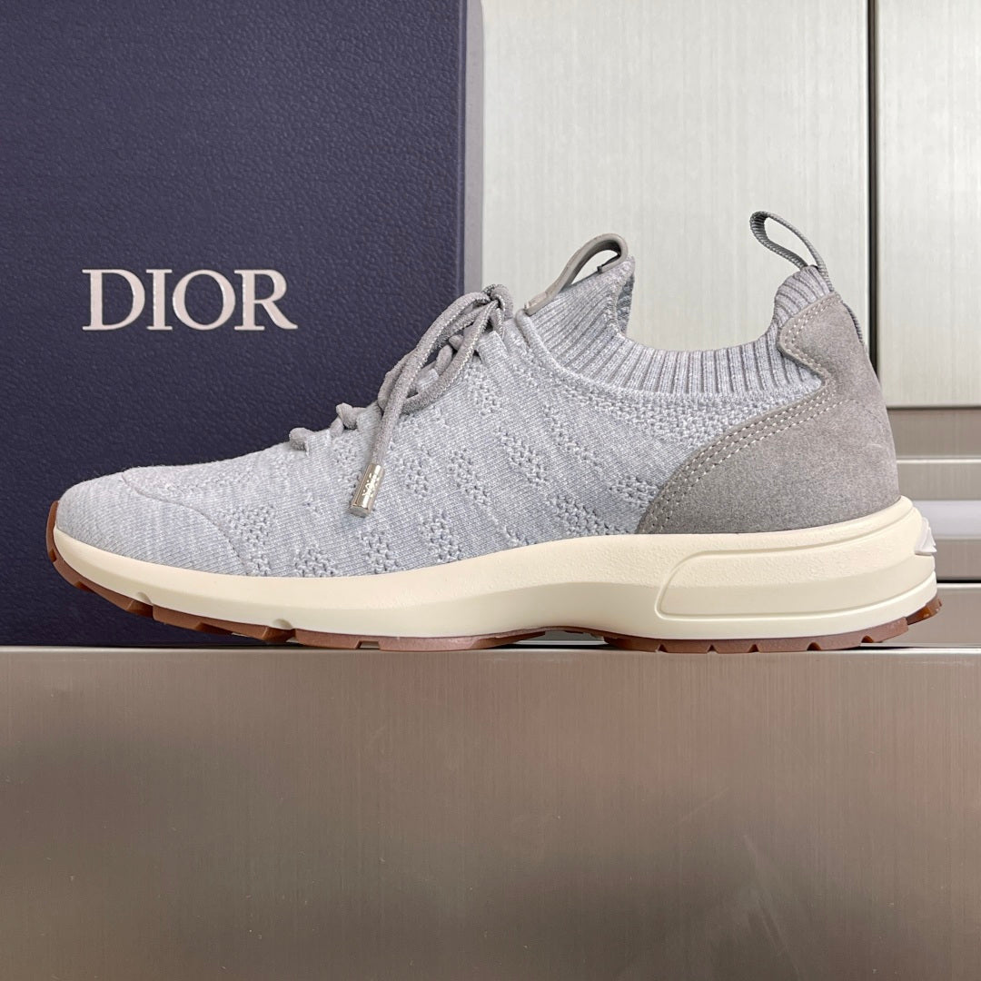 Light grey slip-on knit sneakers with lace-up front and cream sole, Dior on heel