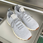 Pair of light grey knit sneakers with lace-up front, cream sole and Dior heel logo