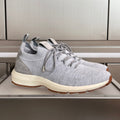 Grey knit unisex sneakers with lace-up detail and cream sole, Dior emblem on heel