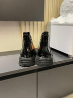 Burberry black patent Chelsea boots with elastic side panels and thick rubber sole
