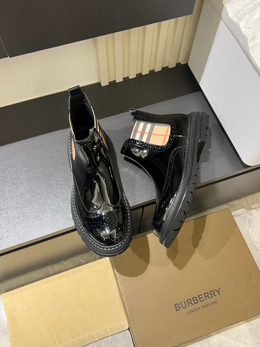 Burberry black patent Chelsea boots with check lining and platform-style sole