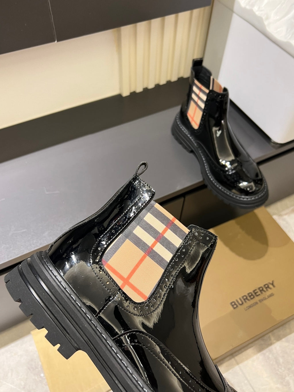 Burberry black patent Chelsea boots with elastic side panels and chunky rubber soles