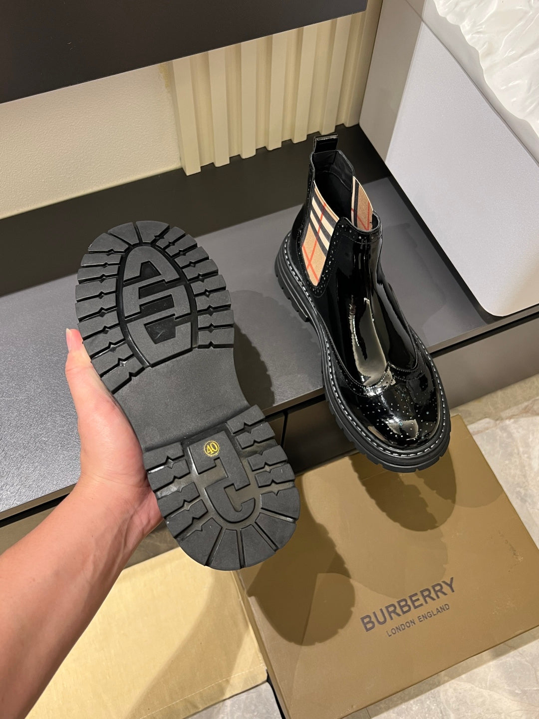 Burberry black patent Chelsea boot with treaded outsole and elastic side panels