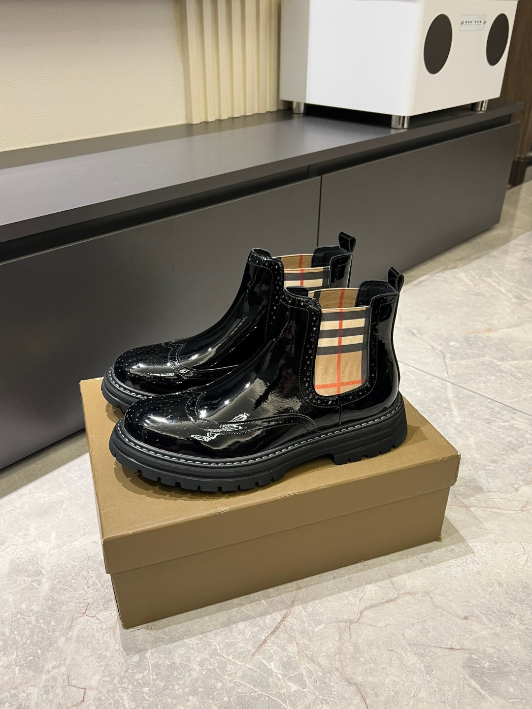 Burberry black patent Chelsea boots with plaid side panel and thick lug sole