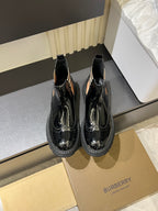 Burberry black patent Chelsea boots with elastic side panels and chunky rubber sole
