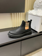 Black leather Chelsea boot with check-panel side detail and thick tread sole