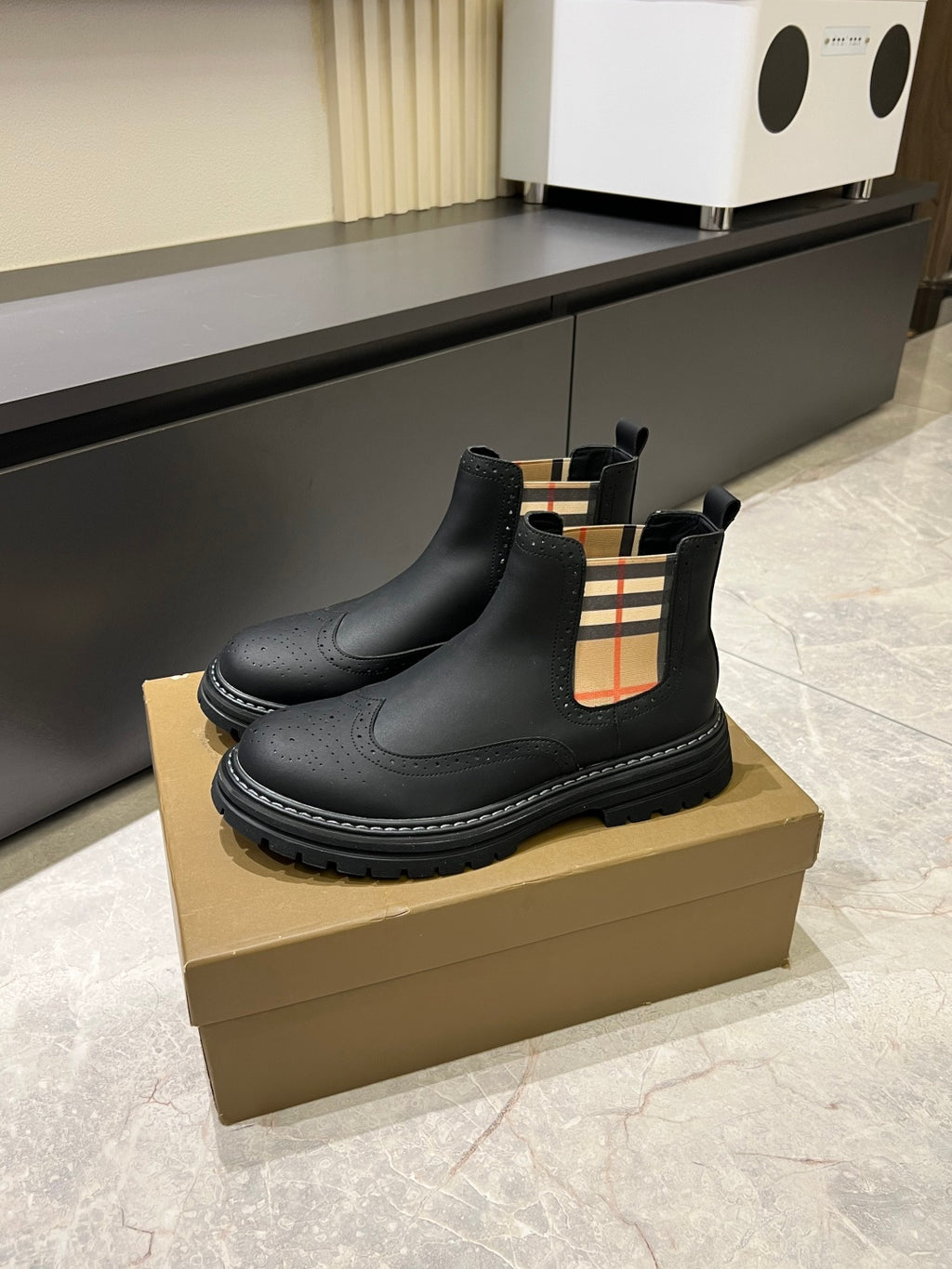 Black leather Chelsea boots with check-panel gore and thick stitched tread sole