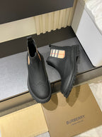 Black leather Chelsea boots with check-panel gore and stitched edge tread sole