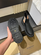 Black Chelsea boot outsole with chunky tread and side check-panel detailing