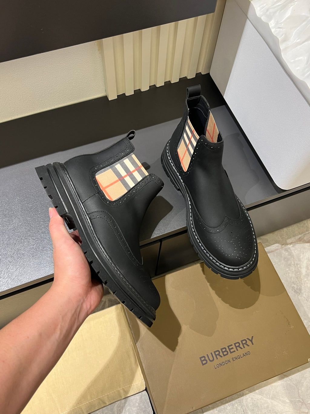 Black leather Chelsea boots with check-panel gore and rugged stitched tread sole