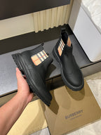 Black leather Chelsea boots with check-panel gore and rugged stitched tread sole