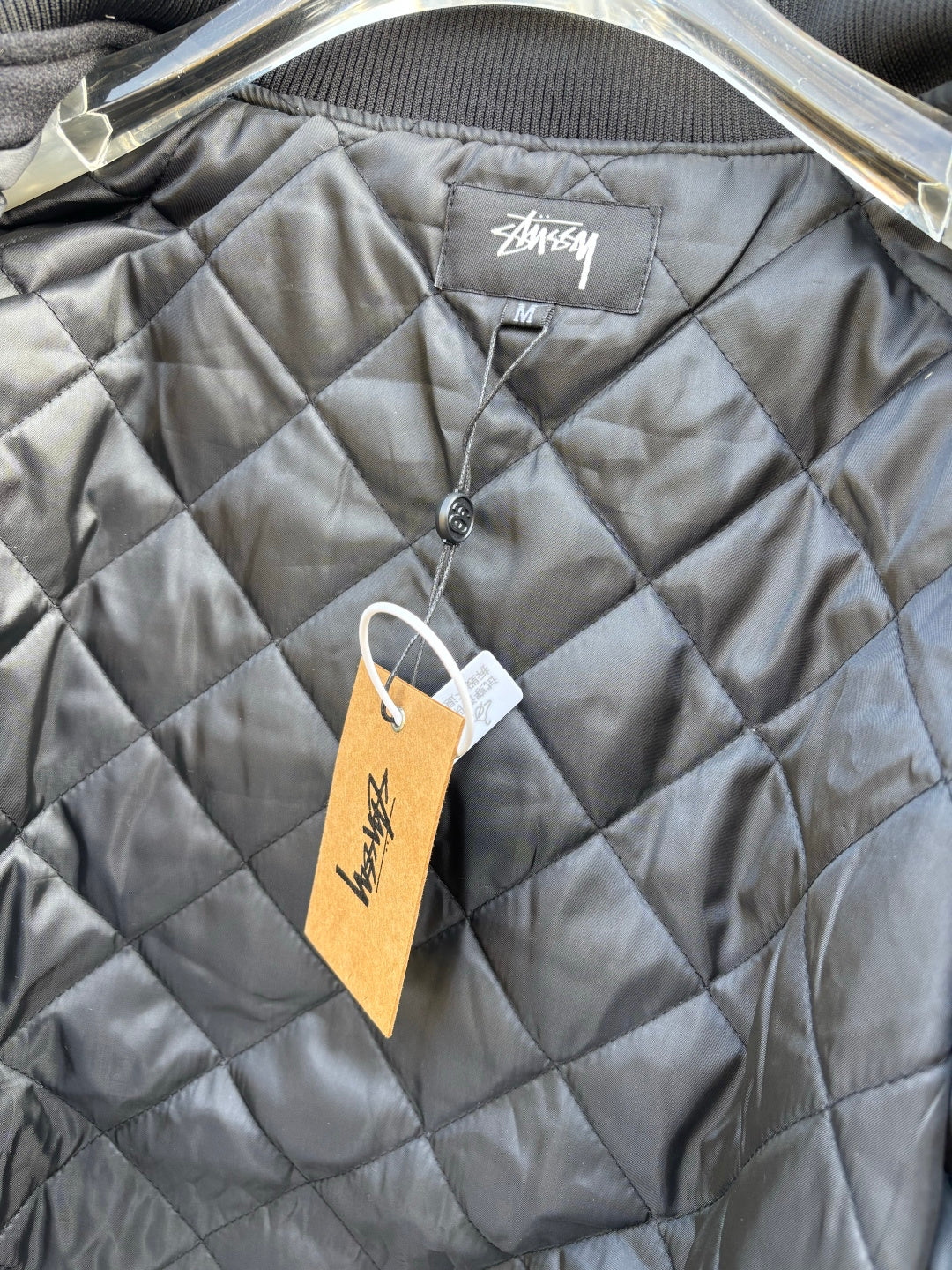 Quilted jacket with Stussy logo patch and front button placket