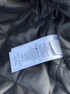 Black quilted jacket care tag on inside lining