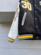 Varsity jacket sleeve with large 30 patch, striped rib cuff, black and white panels