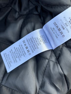 Black quilted jacket care labels on quilted interior lining