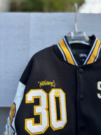 Varsity jacket with 30 patch and yellow Metalhead graphic on black front
