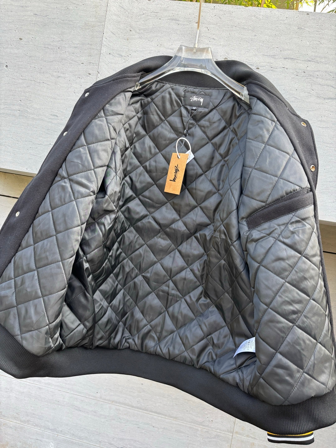 Quilted bomber jacket with ribbed black cuffs and gray diamond quilting