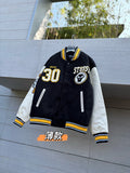 Black varsity jacket with white sleeves, yellow trim, front button and 30 patch