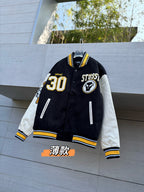 Black varsity jacket with white sleeves, yellow trim, front button and 30 patch