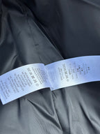 Black fabric with white care label strip and washing symbols printed