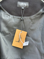 Black bomber jacket neckline close-up with hanging tags and size label