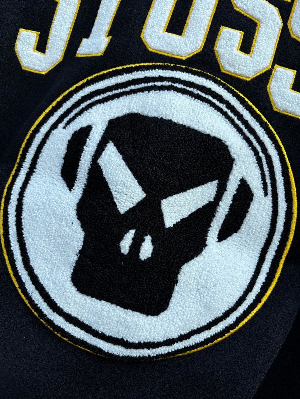 Stussy jacket back circular graphic with dark emblem inside white ring