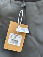 Black bomber jacket close-up of collar area with white swing tag details