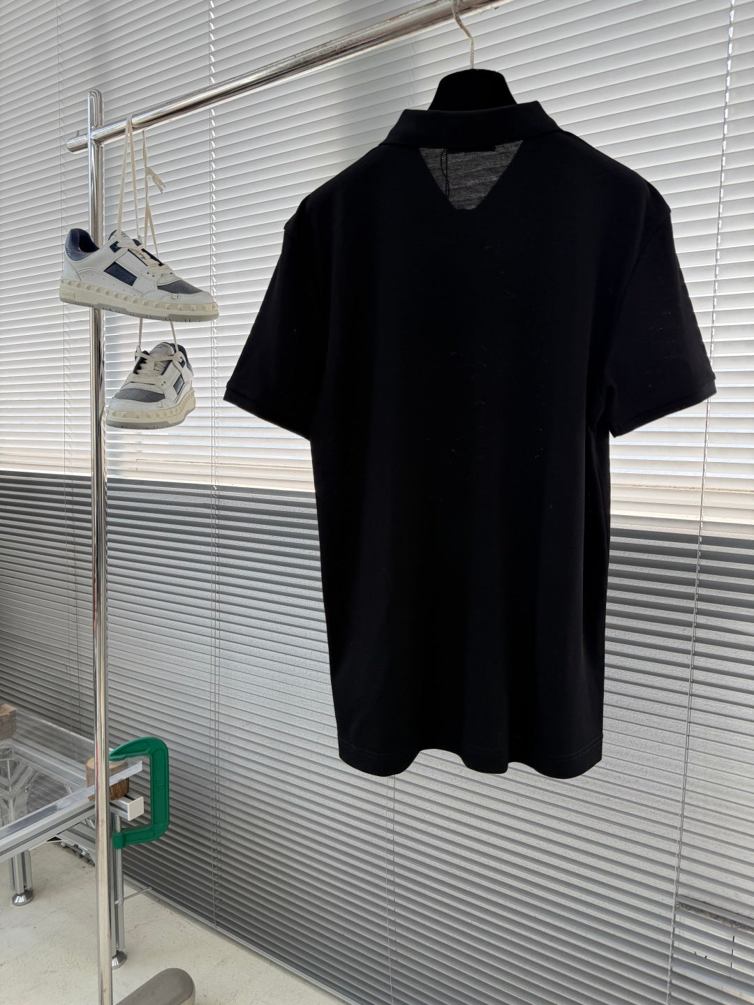 Prada short-sleeve polo shirt on hanger, dark knit with V at placket
