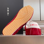 Red suede Amiri sneaker sole with beige AMIRI pattern, white upper