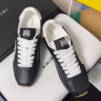 Black leather sneakers with white laces and white tongue lining, presented in a box