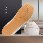 Amiri sneaker outsole with tan tread and AMIRI logo on the shoe interior
