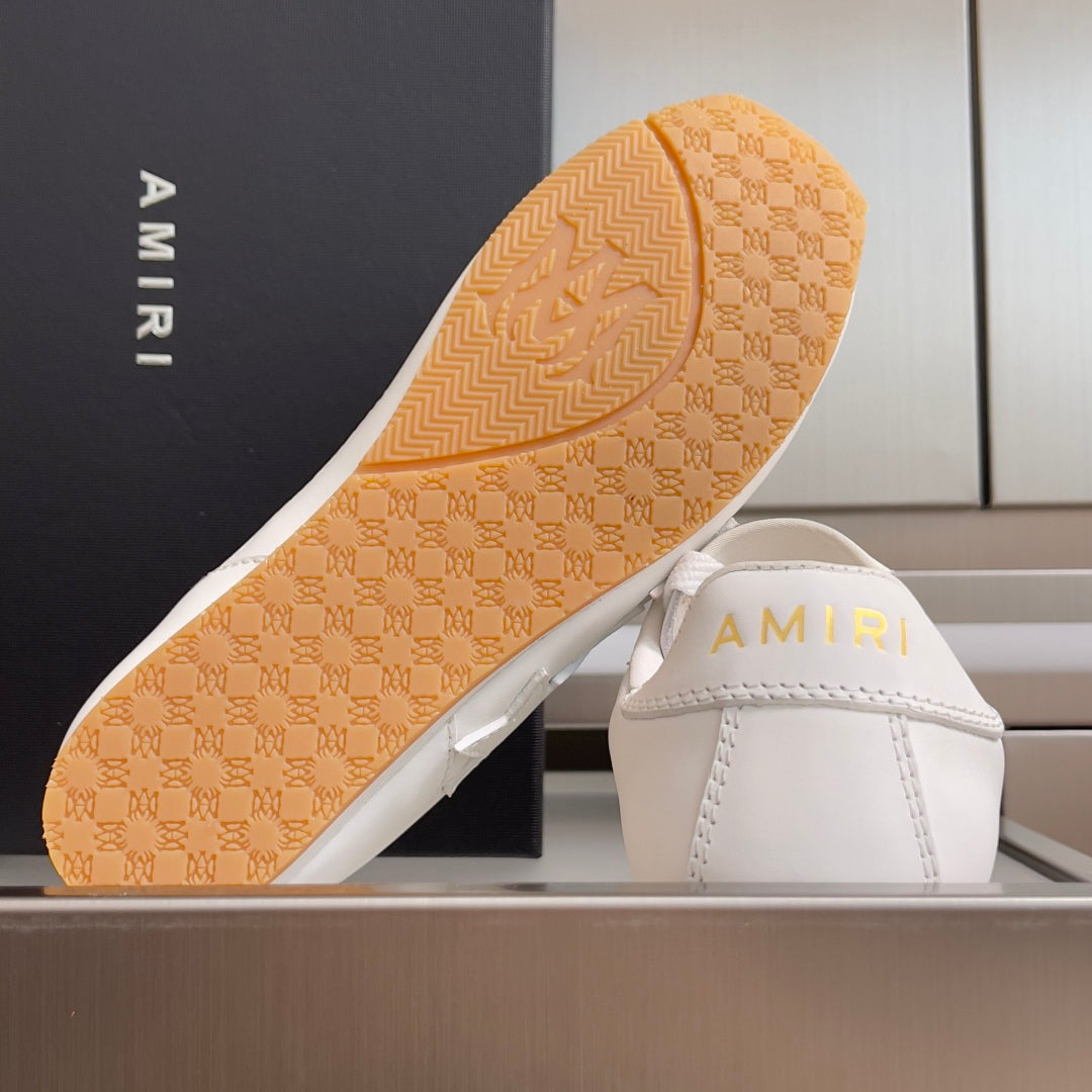 Amiri sneaker outsole with tan tread and AMIRI logo on the shoe interior