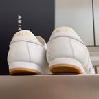 Amiri white sneakers with AMIRI logo on heel tab and gum rubber outsole