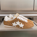 Suede sneakers with three white star patches, tan with white laces and trim