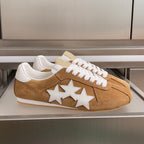 Suede sneakers with three white star patches, tan with white laces and trim