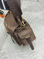Prada mini crossbody bag in dark brown with front flap and adjustable strap