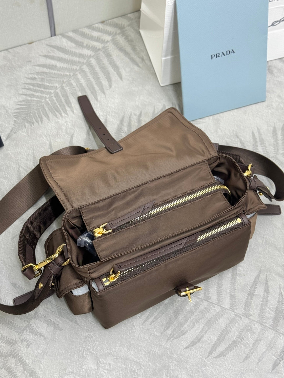 Prada satchel bag in taupe-brown with front zip pockets and crossbody straps