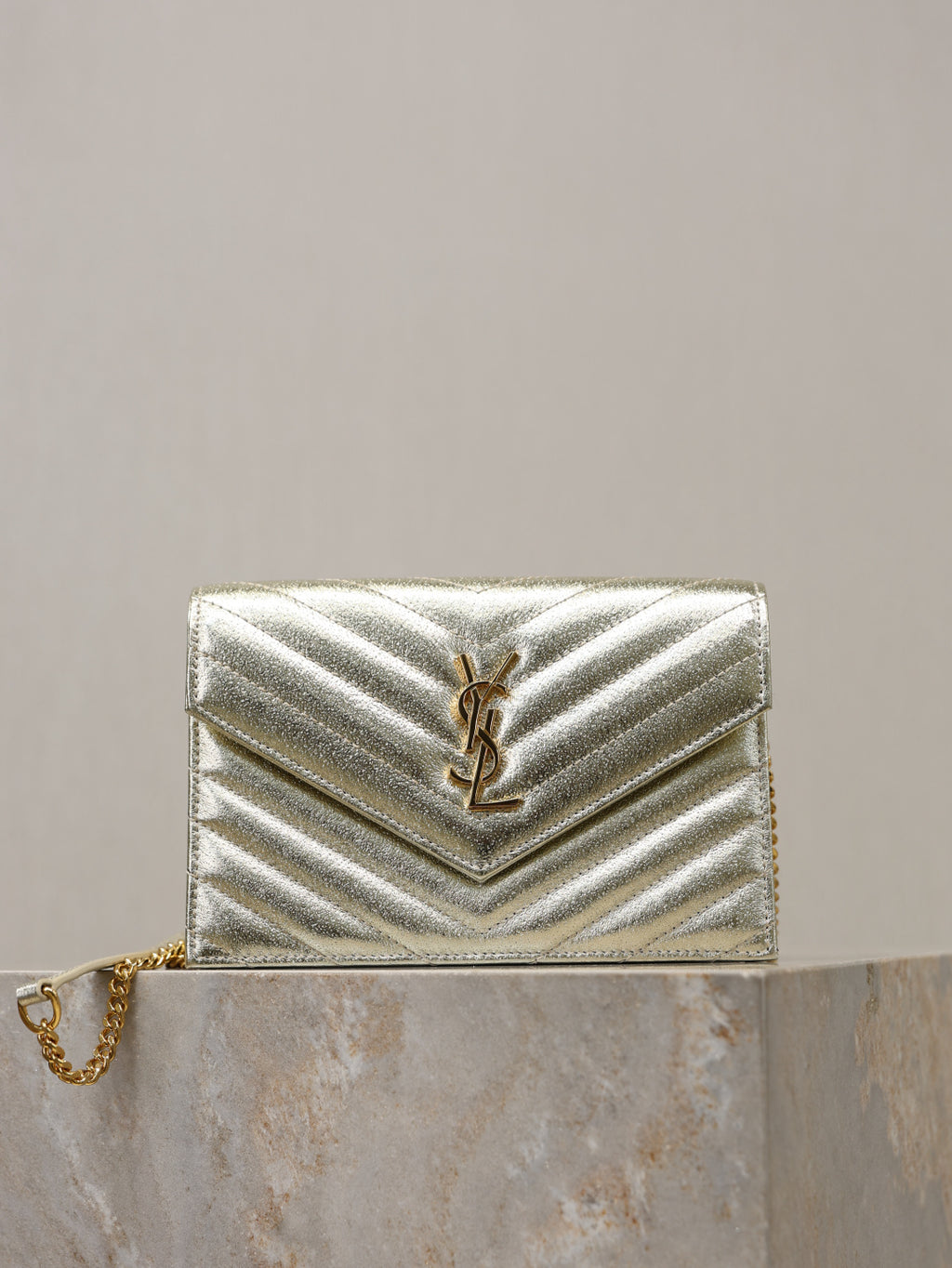 YSL chevron-quilted metallic gold shoulder bag with YSL logo and chain strap