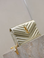 YSL metallic gold chevron flap bag with chain strap, angled view