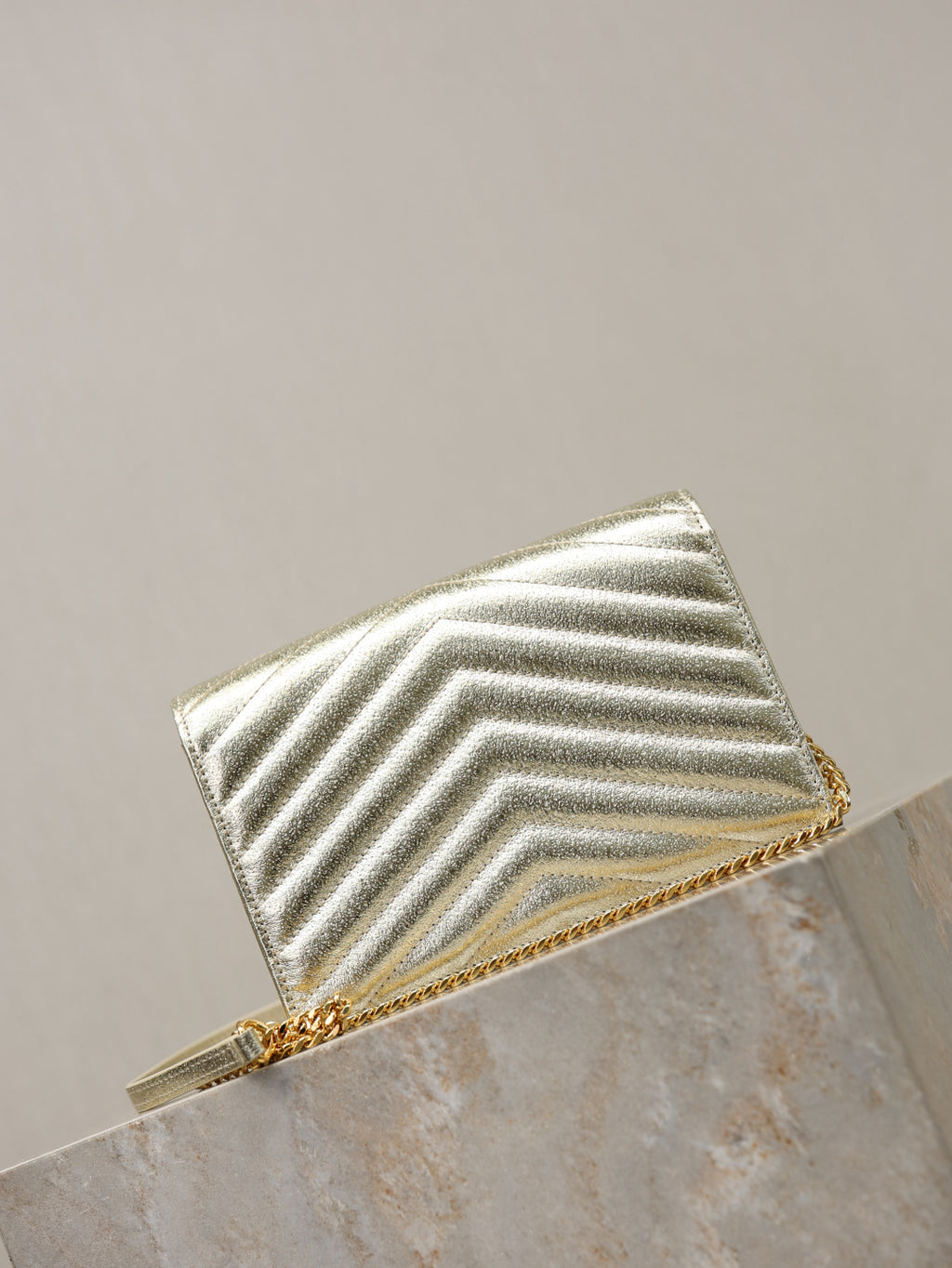 YSL metallic gold chevron flap bag with chain strap, back angled view