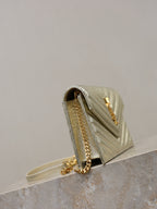 YSL metallic gold small flap bag with chain strap and YSL logo detail