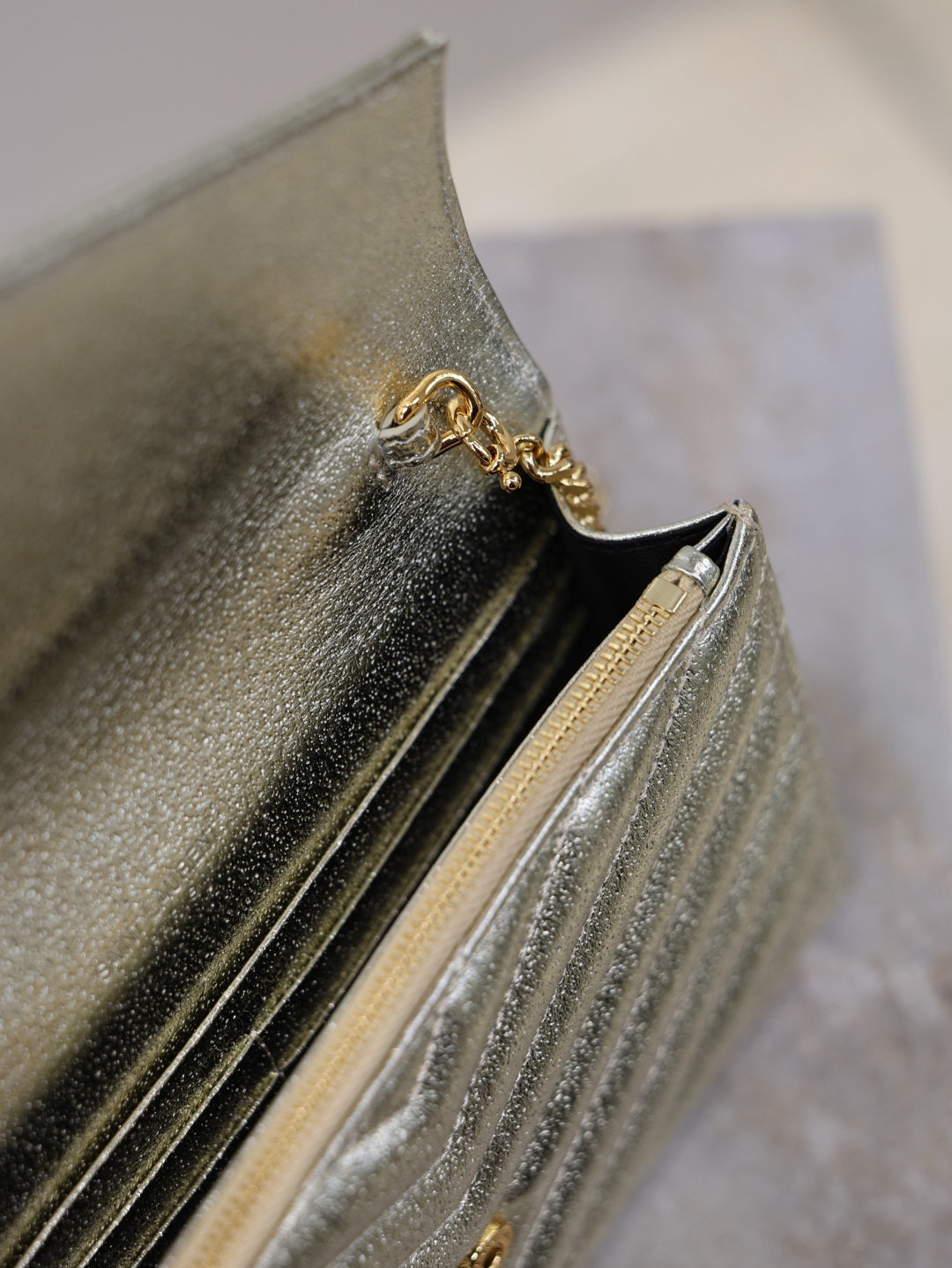 YSL metallic gold interior view of flap bag with chain detail