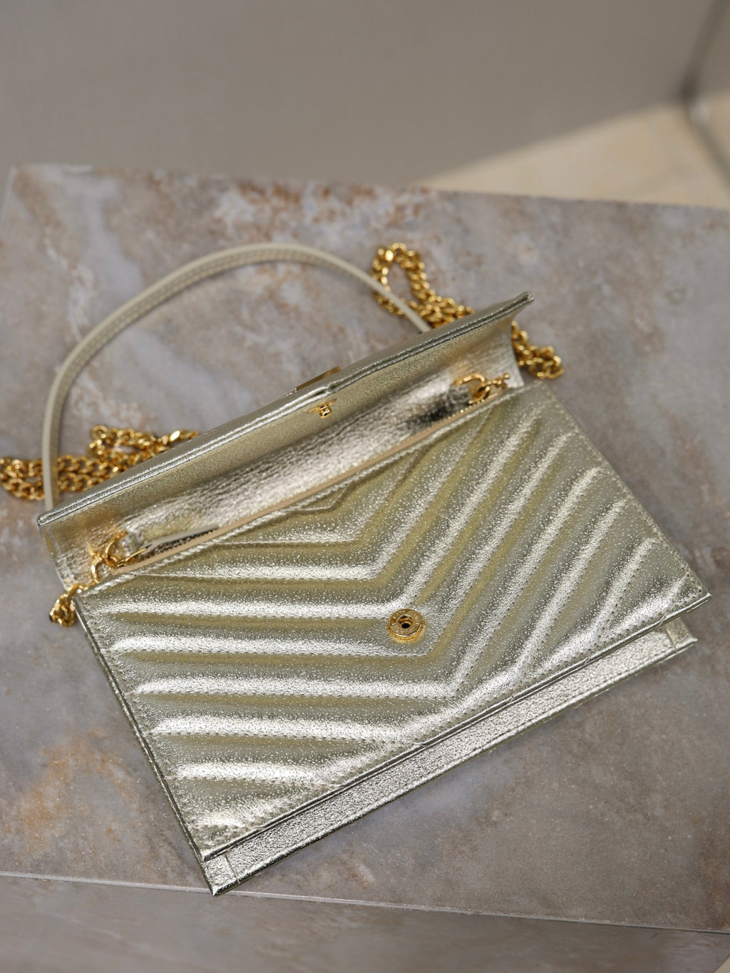 YSL metallic gold flap bag with chain strap and front logo on chevron quilting