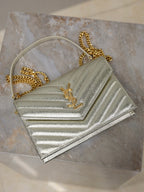 YSL metallic gold mini flap bag with chain strap and YSL logo on chevron quilting